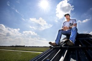 Kenneth sits on top of the 30,000 bushel grain bin on Engeling Farms property [Photo by J. Xu]