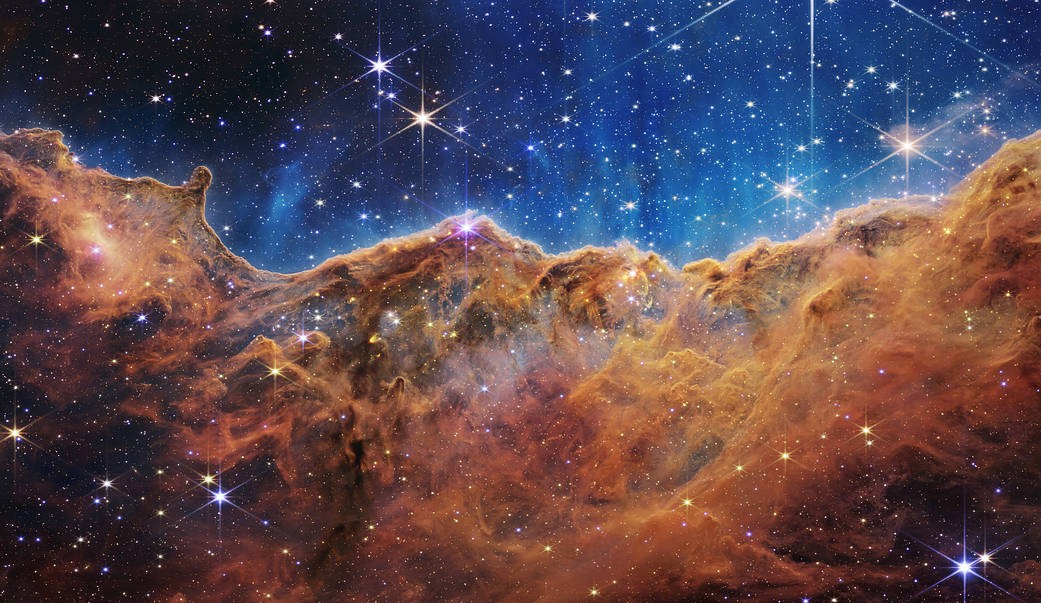 NASA's Webb Reveals Cosmic Cliffs, Glittering Landscape of Star