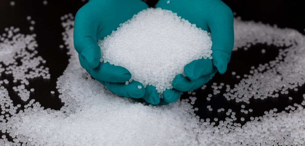 Close-up of plastic polymer granules. hand hold Polymer pellets. polymer plastic. compound polymer. Hands in rubber gloves hold plastic pellets.