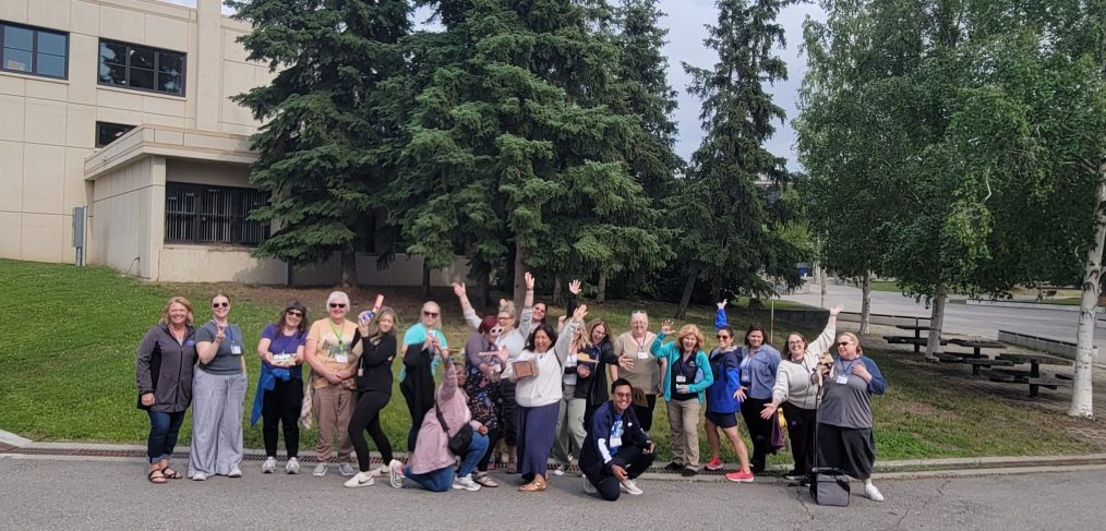 Educators attending 2025 IDEAS workshop pose in a group photo outside on the UAF campus