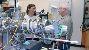 USU Physics doctoral scholar and Utah NASA Space Grant Consortium Fellow Jenny Whiteley, left, examines radiation-induced conductivity instrumentation with Physics Professor J.R. Dennison in his Materials Physics Group. (Photo Credit: USU/M. Muffoletto)
