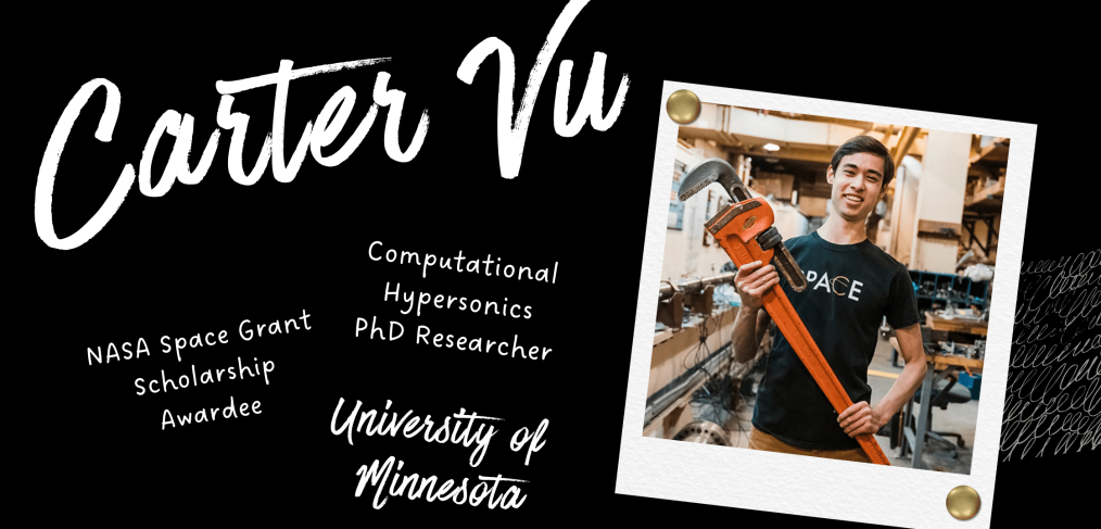 Carter Vu smiling, holding large tool in research lab