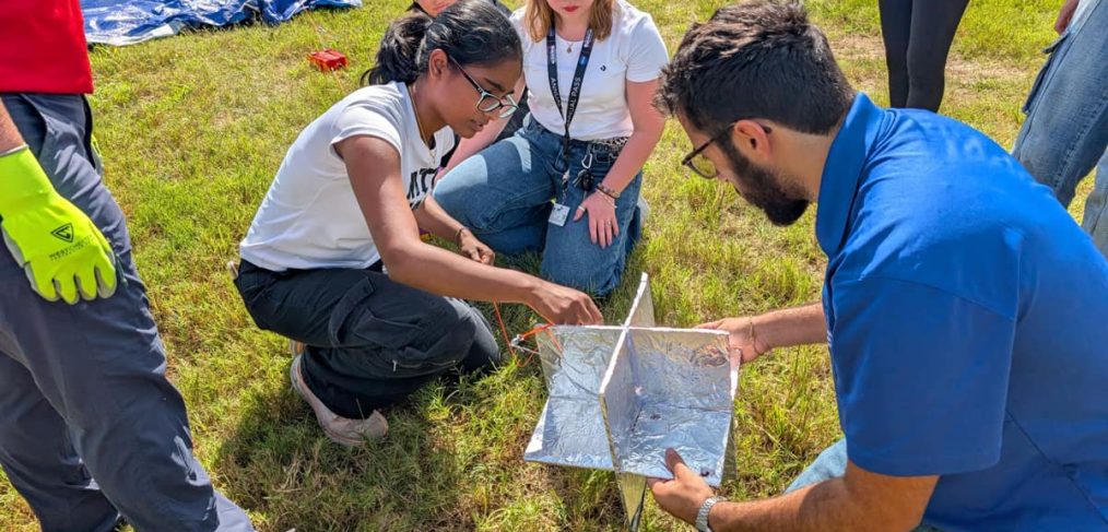 Embry‑Riddle student Whitney Melick was selected to attend the four-day Space Trek Academy, sponsored by NASA Florida Space Grant Consortium and held at the Center for Space Education at Kennedy Space Center Visitor Complex. Here, Melick (center with lanyard) works with her teammates to successfully launch a weather balloon.