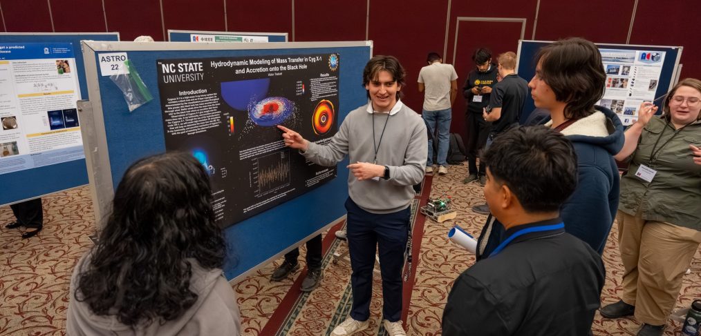 student presents poster