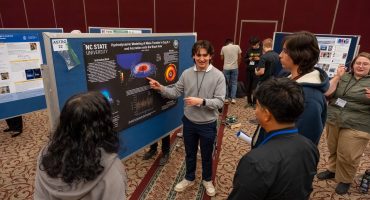 student presents poster