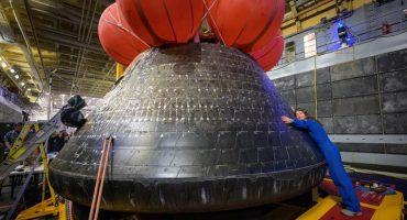 NASA astronaut Christina Koch, Artemis II mission specialist, hugs the Orion spacecraft aboard the USS John P. Murtha, following the spacecraft’s April 11 splashdown in the Pacific Ocean off the California coast. Photo Courtesy of NASA/Bill Ingalls.